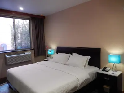a bedroom with a large bed and a window at Quality Inn near Sunset Park in Brooklyn