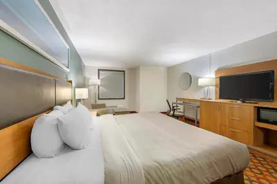 a hotel room with a bed and a flat screen tv at Quality Inn Enola - Harrisburg in Harrisburg
