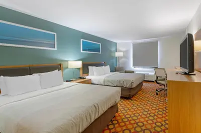 a hotel room with two beds and a flat screen tv at Quality Inn Enola - Harrisburg in Harrisburg