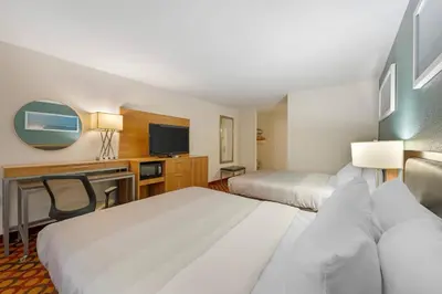 a hotel room with two beds and a flat screen tv at Quality Inn Enola - Harrisburg in Harrisburg