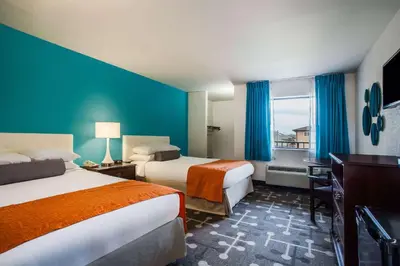 a hotel room with two beds and a window at Howard Johnson by Wyndham Blackwood Near Philadelphia in Blackwood