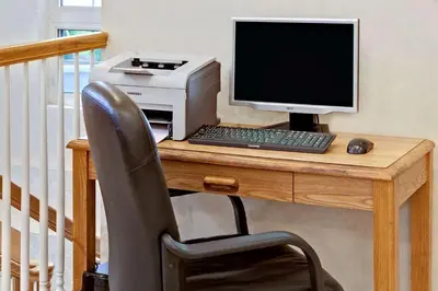a desk with a computer and a printer on it at Howard Johnson by Wyndham Blackwood Near Philadelphia in Blackwood