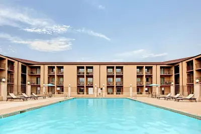 a swimming pool in front of a hotel at Howard Johnson by Wyndham Blackwood Near Philadelphia in Blackwood