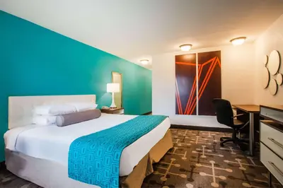 a hotel room with a large bed and a desk at Howard Johnson by Wyndham Blackwood Near Philadelphia in Blackwood