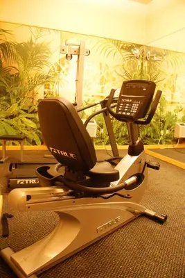 a gym with a chair and a phone on a treadmill at Raritan Hotel in Edison