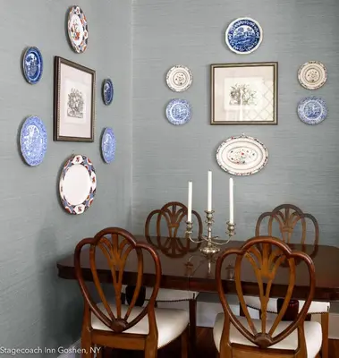 a dining room with blue and white plates on the wall at Stagecoach Inn in Goshen