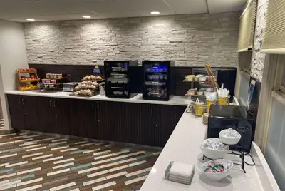 a bakery with a counter with food on it at Days Inn by Wyndham Wilmington Brandywine in Talleyville