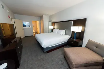 a hotel room with a bed and a couch at Hilton Scranton & Conference Center in Scranton