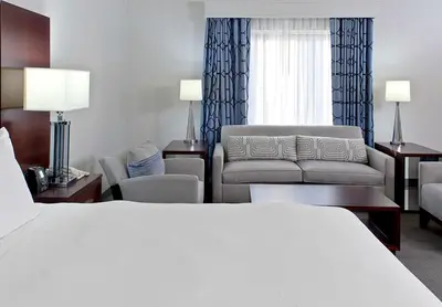 a hotel room with a bed and a couch at Hilton Scranton & Conference Center in Scranton