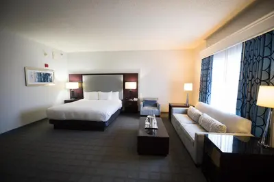 a hotel room with a bed and a couch at Hilton Scranton & Conference Center in Scranton