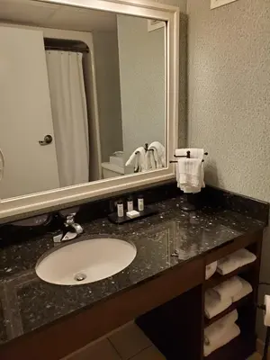 a bathroom counter with a sink and a mirror at Heritage Hills Golf Resort & Conference Center in York