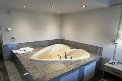 a bathroom with a tub in a room at TraveIodge by Wyndham Parsippany in Parsippany