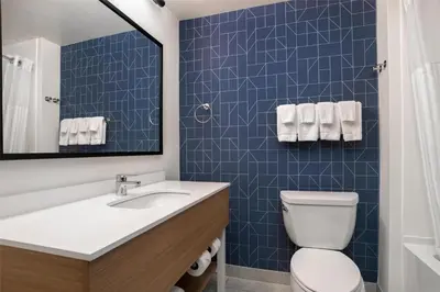 a bathroom with a white toilet and a sink at Spark by Hilton Rahway in Rahway