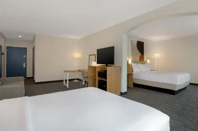 a hotel room with two beds and a television at Spark by Hilton Rahway in Rahway