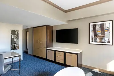 a hotel room with a flat screen tv on a wall at Hilton Club New York in New York