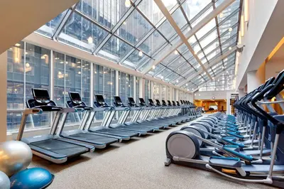 a large gym with rows of exercise machines at Hilton Club New York in New York