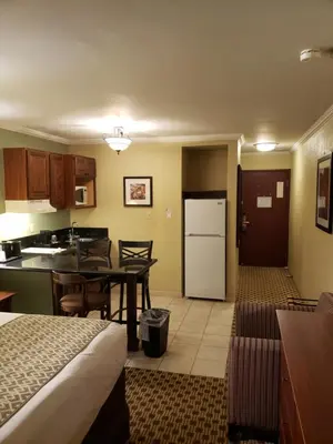 a hotel room with a kitchen and a dining room at Baymont by Wyndham Pompton Plains/Wayne in Pompton Plains