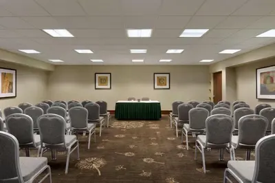 a conference room with chairs and a table in the middle at Embassy Suites by Hilton Piscataway Somerset in Piscataway