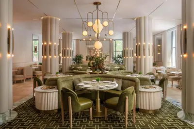a lobby with couches and tables and a chandelier at Waldorf Astoria New York in New York