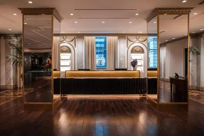 a lobby with a bar in a building at Waldorf Astoria New York in New York