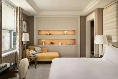 a hotel room with a bed and a couch at Waldorf Astoria New York in New York