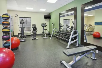 a gym with weights and exercise equipment at Hampton Inn Clinton in Clinton