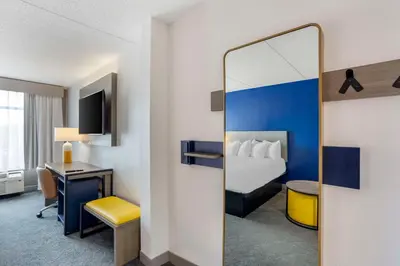 a hotel room with a bed and a mirror at Comfort Inn & Suites Voorhees-Mt Laurel in Voorhees