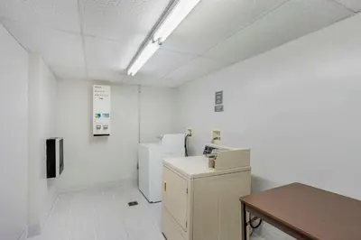a room with white walls and two refrigerators and a table at Comfort Inn & Suites Voorhees-Mt Laurel in Voorhees