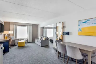 a hotel room with a table and chairs at Comfort Inn & Suites Voorhees-Mt Laurel in Voorhees