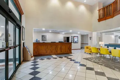 a lobby of a hospital with yellow chairs and a table at Comfort Inn & Suites Voorhees-Mt Laurel in Voorhees