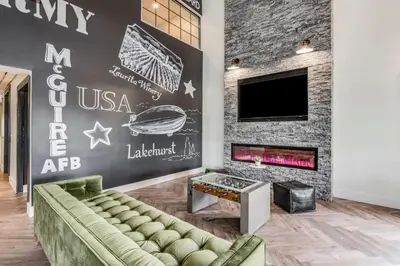 a living room with a couch and a fireplace at SureStay Plus Hotel by Best Western McGuire AFB Jackson in Cookstown