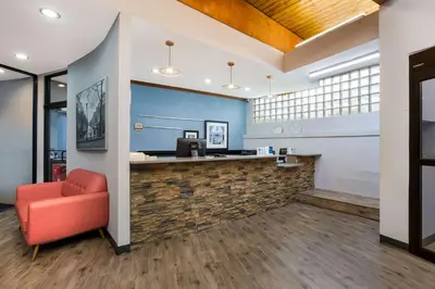 a lobby of a dental office with a red chair at Best Western Bordentown Inn in Bordentown