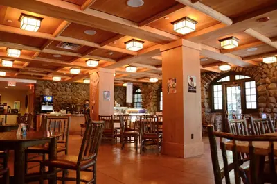 a dining room with tables and chairs in a restaurant at Overlook Lodge and Stone Cottages at Bear Mountain in Highland Falls