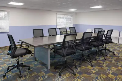 a conference room with a long table and chairs at Baymont by Wyndham Westampton in Westampton Township