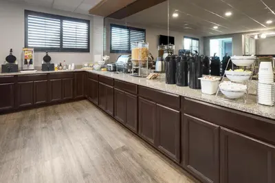 a restaurant with a counter with bowls of food at Baymont by Wyndham Westampton in Westampton Township