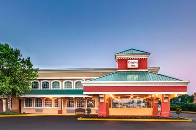 a restaurant with a red building with a green roof at Knights Inn Mount Laurel in Mount Laurel