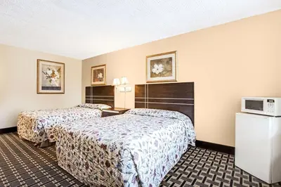a hotel room with two beds and a tv at Knights Inn Mount Laurel in Mount Laurel