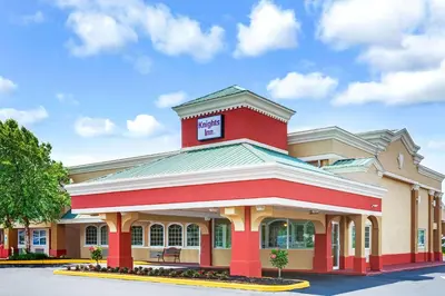 a red building with a sign on top of it at Knights Inn Mount Laurel in Mount Laurel