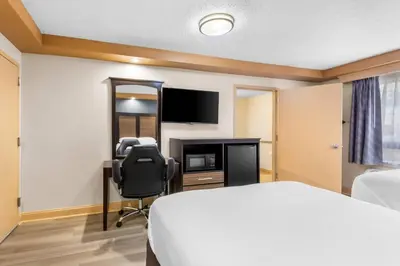 a hotel room with a bed and a television at Econo Lodge Woodbridge in Iselin
