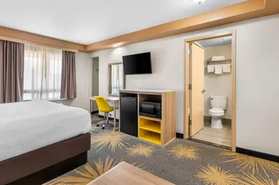a hotel room with a bed and a desk at Econo Lodge Woodbridge in Iselin