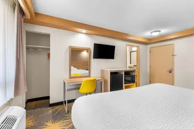 a hotel room with a bed and a desk at Econo Lodge Woodbridge in Iselin
