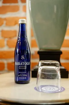 a blue bottle of soda sitting on a table at Lancaster Arts Hotel in Lancaster