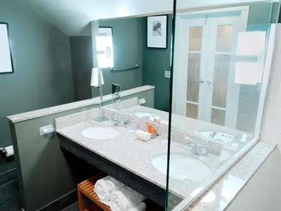 a bathroom with two sinks and a large mirror at Lancaster Arts Hotel in Lancaster