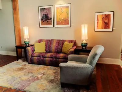 a living room with a couch and a chair at Lancaster Arts Hotel in Lancaster