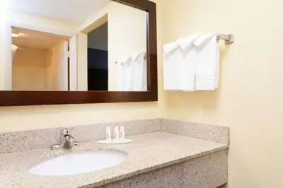 a bathroom with a sink and a mirror at Days Inn by Wyndham Wilkes Barre in Wilkes-Barre