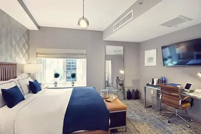 a large bedroom with a large bed and a desk at Artezen Hotel in New York