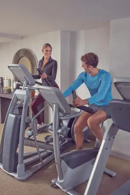 two women riding on a treadmill in a gym at Artezen Hotel in New York