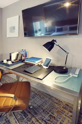 a desk with a lamp and two laptops on it at Artezen Hotel in New York