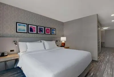 a large white bed in a hotel room at Hilton Garden Inn Hamilton in Bordentown