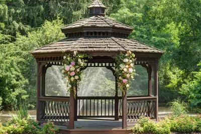 a gazebo with flowers in a garden at Hilton Garden Inn Hamilton in Bordentown